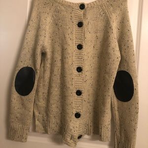Beige sweater with button back and elbow accents.